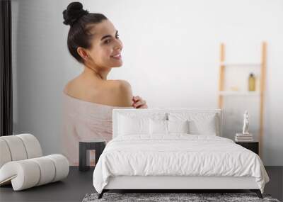 Beautiful happy woman wearing stylish bathrobe in light bathroom. Space for text Wall mural