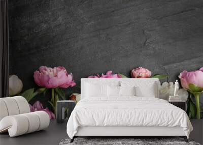 Beautiful peonies on black slate table, flat lay. Space for text Wall mural