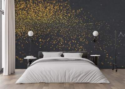 Beautiful shiny golden glitter on black background, closeup Wall mural