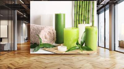 Beautiful spa composition with green candles on table Wall mural