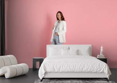 Beautiful woman in stylish white jacket on pink background Wall mural