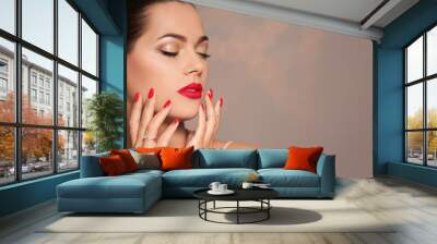 Beautiful young woman with bright manicure on blurred background, space for text. Nail polish trends Wall mural