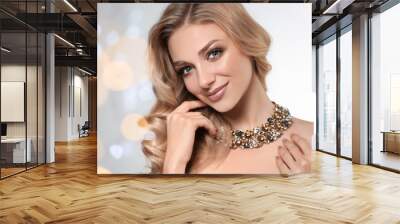 Beautiful young woman with elegant jewelry against defocused lights. Space for text Wall mural