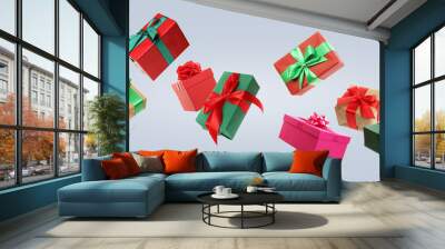 Beautifully wrapped gift boxes flying on light background Wall mural