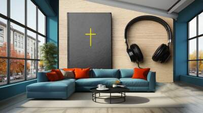 Bible and headphones on wooden background, top view. Religious audiobook Wall mural