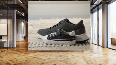 Big and small sneakers on carpet indoors, closeup Wall mural