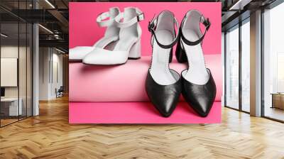 Black and white stylish female shoes on pink background Wall mural