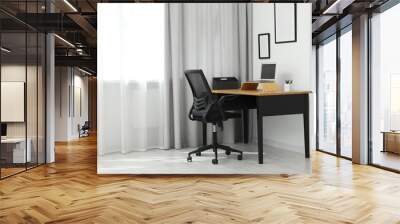 Black chair, laptop and desk in office Wall mural