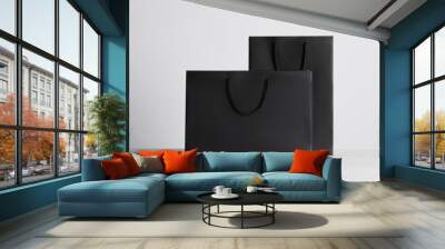 Black paper bags on white wooden table Wall mural