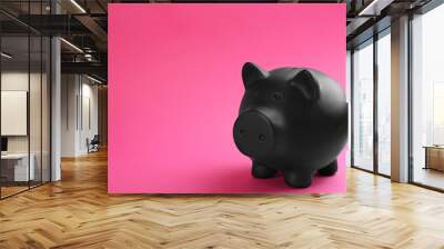 Black piggy bank on pink background. Space for text Wall mural