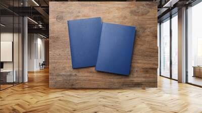 Blank blue passports on wooden table, flat lay Wall mural