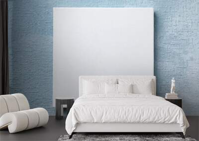 Blank canvas hanging on light blue wall, space for text Wall mural