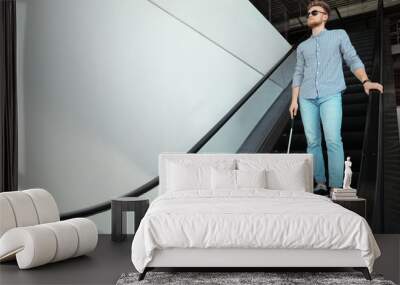 Blind person with long cane on escalator indoors. Space for text Wall mural