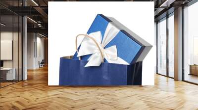 Blue paper shopping bag with gift box on white background Wall mural