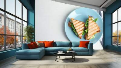 Blue plate with tasty sandwiches on white table, top view. Space for text Wall mural