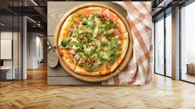 Board with delicious vegetarian pizza on wooden table, top view Wall mural