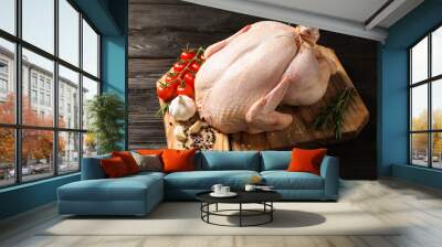 Board with raw turkey and ingredients on wooden background Wall mural