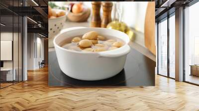 Boiling potatoes in pot on stove in kitchen Wall mural