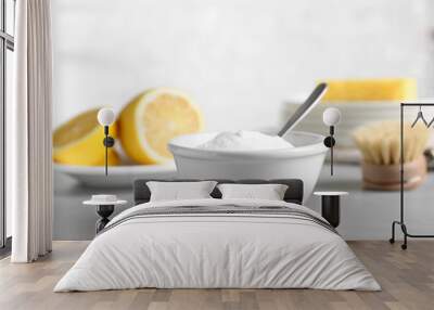 Bowl of baking soda, brush and lemon on light grey table Wall mural