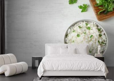 Bowl of boiled rice served on wooden table, top view with space for text Wall mural