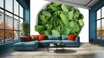 Bowl of fresh green healthy baby spinach on white background, top view Wall mural