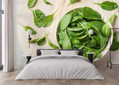 Bowl of fresh green healthy spinach on table, flat lay Wall mural