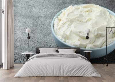 Bowl of tasty cream cheese on grey table. Space for text Wall mural