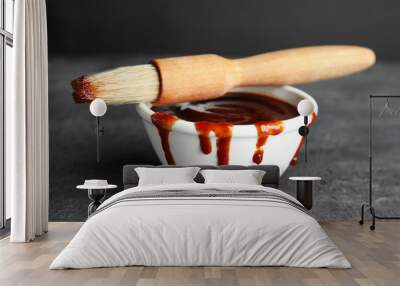 Bowl with barbecue sauce and brush on grey table Wall mural