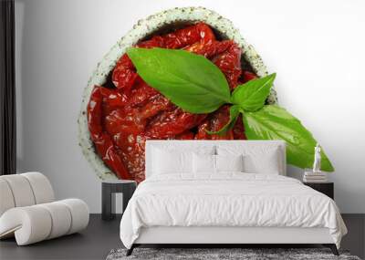 Bowl with sun dried tomatoes and green leaves on white background, top view Wall mural