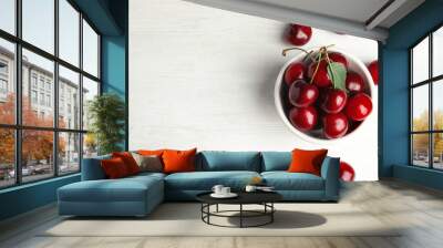 Bowl with sweet cherries on white wooden table, top view. Space for text Wall mural