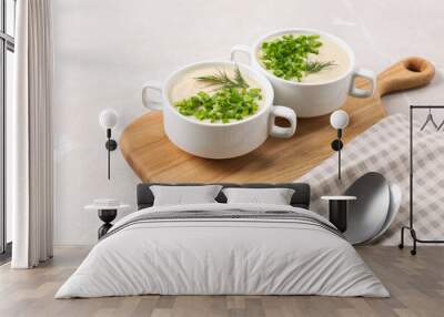 Bowls with tasty creamy soup of parsnip served on light grey background Wall mural