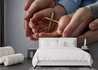 Boy and his godparents holding cross on white background, closeup Wall mural