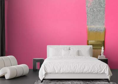 Brush painting with silver glitter on pink background, top view. Space for text. Creative concept Wall mural