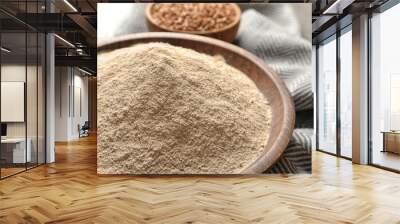 Buckwheat flour in wooden bowl on table, closeup Wall mural