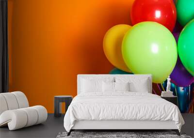 Bunch of bright balloons on color background with space for design Wall mural