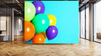 Bunch of bright balloons on color background with space for design Wall mural