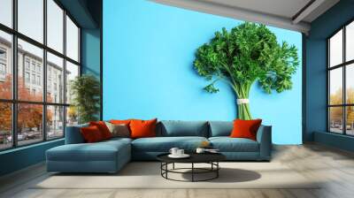 Bunch of fresh green parsley on blue background, top view. Space for text Wall mural