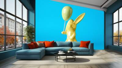 Bunny ceramic figure as Easter decor on blue background Wall mural