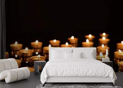 Burning candles on mirror surface in darkness Wall mural