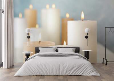 Burning candles on table against color background, closeup Wall mural