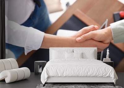 Business partners shaking hands at table after meeting in office, closeup Wall mural