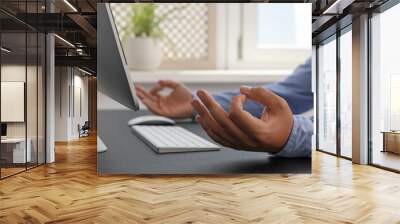 Businessman meditating at workplace, closeup. Zen concept Wall mural