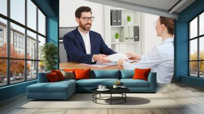 Businesspeople working with documents at table in office Wall mural