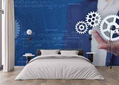 Businesswoman demonstrating gear mechanism on blue background, closeup. Banner design Wall mural