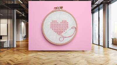 Canvas with embroidered heart and needle in hoop on pink background, top view Wall mural