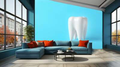 Ceramic model of tooth on color background. Space for text Wall mural