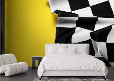 Checkered finish flag on yellow background, top view. Space for text Wall mural