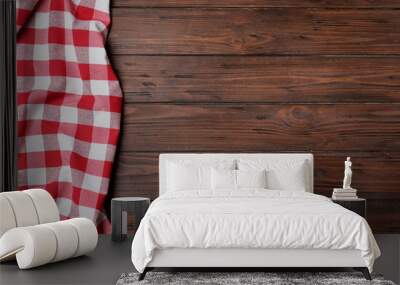 Checkered picnic blanket on wooden background, top view. Space for text Wall mural