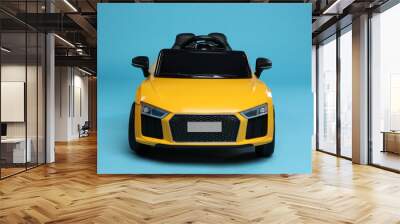 Child's electric toy car on light blue background Wall mural