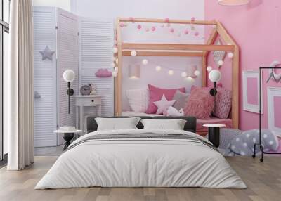 Child's room interior with comfortable bed and garland Wall mural